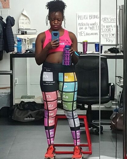 Female wearing black periodic table yoga leggings