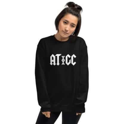 Female model wearing a black sweatshirt with a logo that says AT / GC with a stylized DNA