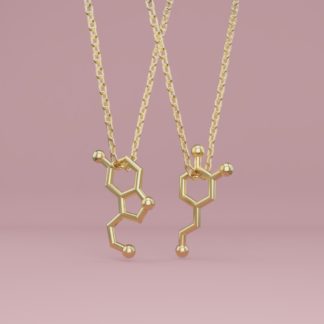 A serotonin and a dopamine molecule necklace in gold