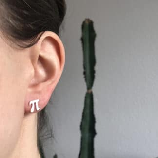 Pi symbol earring studs silver worn by a model